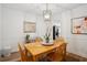 Traditional dining room with a light wood table, matching chairs, and modern light fixture at 1771 Defoor Nw Ave # D, Atlanta, GA 30318