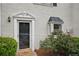 Close up of townhouse entryway with charming accents and well-maintained landscaping at 1771 Defoor Nw Ave # D, Atlanta, GA 30318