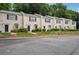 Row of charming townhouses featuring brick facade, manicured lawns, and ample parking at 1771 Defoor Nw Ave # D, Atlanta, GA 30318
