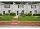 Charming townhouse with brick facade, well-maintained lawn, and black shutters on light colored brick at 1771 Defoor Nw Ave # D, Atlanta, GA 30318