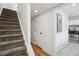 Interior with stairwell access, white walls, and view into updated kitchen with tile floors at 1771 Defoor Nw Ave # D, Atlanta, GA 30318