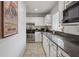 Clean kitchen featuring granite counters, stainless steel appliances, and white cabinetry at 1771 Defoor Nw Ave # D, Atlanta, GA 30318