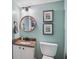Cozy powder room with granite countertop, stylish lighting, and decorative artwork at 1771 Defoor Nw Ave # D, Atlanta, GA 30318