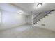 Basement with tile flooring, white walls, and stairs with black railings at 2668 Jefferson Ter, East Point, GA 30344