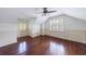 Upstairs bonus room with hardwood floors, wainscoting and white shutters at 2668 Jefferson Ter, East Point, GA 30344