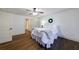 Bedroom with wood floors, white trim, ceiling fan and an ensuite bathroom and closet at 2668 Jefferson Ter, East Point, GA 30344
