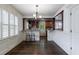 Bright dining area with hardwood floors, a view of the kitchen, and natural light from the shutters at 2668 Jefferson Ter, East Point, GA 30344
