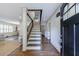 Inviting foyer featuring hardwood floors, staircase, and an open view into the living area at 2668 Jefferson Ter, East Point, GA 30344