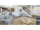 Open concept living room with stylish seating, flowing into the dining area and staircase at 2668 Jefferson Ter, East Point, GA 30344