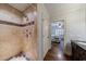 Walk-in shower with beige tile and dark brown accent stripe and hardware at 2668 Jefferson Ter, East Point, GA 30344