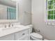 Bright bathroom with white vanity, modern fixtures, and a window with a green view at 2696 Chancellor Way, Duluth, GA 30096