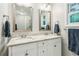 Bathroom vanity with double sinks and granite counters plus framed mirrors and lots of natural light at 2696 Chancellor Way, Duluth, GA 30096
