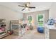 Bright bedroom features a bunk bed, ceiling fan, and natural light from two windows at 2696 Chancellor Way, Duluth, GA 30096