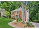 Beautiful two-story brick home with a vibrant lawn, mature trees, and a side-entry garage at 2696 Chancellor Way, Duluth, GA 30096
