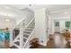 Open foyer featuring hardwood floors, stairway with iron balusters, and views to the dining and living room at 2696 Chancellor Way, Duluth, GA 30096