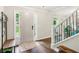 Inviting foyer with hardwood floors, a decorative rug, staircase, and an abundance of natural light at 2696 Chancellor Way, Duluth, GA 30096
