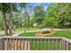 View from the porch to the front yard featuring mature trees, landscaping, and a circular driveway at 2696 Chancellor Way, Duluth, GA 30096