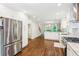 Spacious kitchen with a stainless steel refrigerator, ample cabinetry, and hardwood floors at 2696 Chancellor Way, Duluth, GA 30096