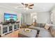 Relaxing living room featuring a sectional sofa, hardwood floors, and a modern media center at 2696 Chancellor Way, Duluth, GA 30096
