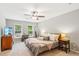 Calm main bedroom features a ceiling fan, neutral walls, and windows that provide lots of natural light at 2696 Chancellor Way, Duluth, GA 30096