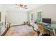 Bright office featuring a decorative rug, a ceiling fan, neutral walls, and two windows at 2696 Chancellor Way, Duluth, GA 30096