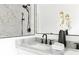 Bathroom featuring marble countertop, dual sinks, and modern black fixtures at 2873 Bob White Sw Dr, Atlanta, GA 30311