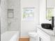 Bright bathroom featuring a modern vanity, marble tile, and black accents at 2873 Bob White Sw Dr, Atlanta, GA 30311