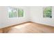 Empty bedroom featuring hardwood floors, white walls, and large windows with natural light at 2873 Bob White Sw Dr, Atlanta, GA 30311