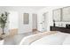 Light, bright bedroom featuring hardwood floors, contemporary art, and multiple doorways at 2873 Bob White Sw Dr, Atlanta, GA 30311