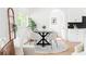 Cozy dining area with a round table, stylish chairs, and modern decor, next to open kitchen space at 2873 Bob White Sw Dr, Atlanta, GA 30311