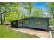 Mid-century modern home featuring large windows and lush landscaping at 2873 Bob White Sw Dr, Atlanta, GA 30311