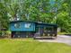 Stunning renovated home with an elegant blue and black exterior and well-manicured lawn at 2873 Bob White Sw Dr, Atlanta, GA 30311