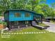 Inviting two-story exterior showcasing a blue-paneled home with a black-brick foundation and manicured lawn at 2873 Bob White Sw Dr, Atlanta, GA 30311