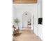 Bright hallway with hardwood floors, arched doorways, and access to the living spaces at 2873 Bob White Sw Dr, Atlanta, GA 30311