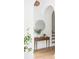 Hallway with a table with decor, arched doorways and natural light creating an inviting and modern aesthetic at 2873 Bob White Sw Dr, Atlanta, GA 30311