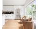 Bright kitchen featuring white cabinets, stainless steel appliances, and a view of the outdoors through large windows at 2873 Bob White Sw Dr, Atlanta, GA 30311