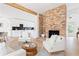 Bright, open living space showcasing a brick fireplace, kitchen, and dining area, perfect for entertaining at 2873 Bob White Sw Dr, Atlanta, GA 30311