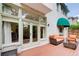 Charming back porch with brick exterior, open furniture, and multiple windows at 42 Greenland Trce, Atlanta, GA 30342