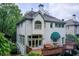 Back of house showing an elevated deck and awning over a sitting area at 42 Greenland Trce, Atlanta, GA 30342