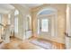 Bright foyer with hardwood floors, decorative rug, paneled walls, and a leaded glass door at 42 Greenland Trce, Atlanta, GA 30342