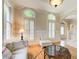 Cozy living room with hardwood floors, arched windows, and comfortable seating arrangement at 42 Greenland Trce, Atlanta, GA 30342