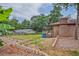 Brick house with a wooden deck, lush green lawn, and a fenced backyard, offering a private outdoor space at 4296 Linda Sw Ln, Lilburn, GA 30047