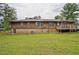 Expansive backyard with a wooden deck, offering ample space for outdoor activities and relaxation at 4296 Linda Sw Ln, Lilburn, GA 30047
