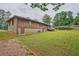 Spacious backyard featuring a wooden deck, lush green lawn, and mature trees, creating a serene outdoor space at 4296 Linda Sw Ln, Lilburn, GA 30047
