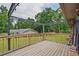 Inviting wooden deck featuring overhead lighting and a scenic view of the lush green backyard at 4296 Linda Sw Ln, Lilburn, GA 30047