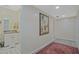 Hallway adjacent to bathroom features updated vanity and large painting at 4296 Linda Sw Ln, Lilburn, GA 30047