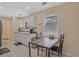 Bright kitchen area with eat-in nook, white cabinets, and backyard view at 4296 Linda Sw Ln, Lilburn, GA 30047