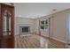 Living room features fireplace, hardwood floors, and a window at 4296 Linda Sw Ln, Lilburn, GA 30047