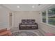 Comfortable living room featuring a leather reclining sofa and a large window for natural light at 4296 Linda Sw Ln, Lilburn, GA 30047