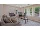 Open living area with a view into the second seating area with reclining couches and natural light at 4296 Linda Sw Ln, Lilburn, GA 30047